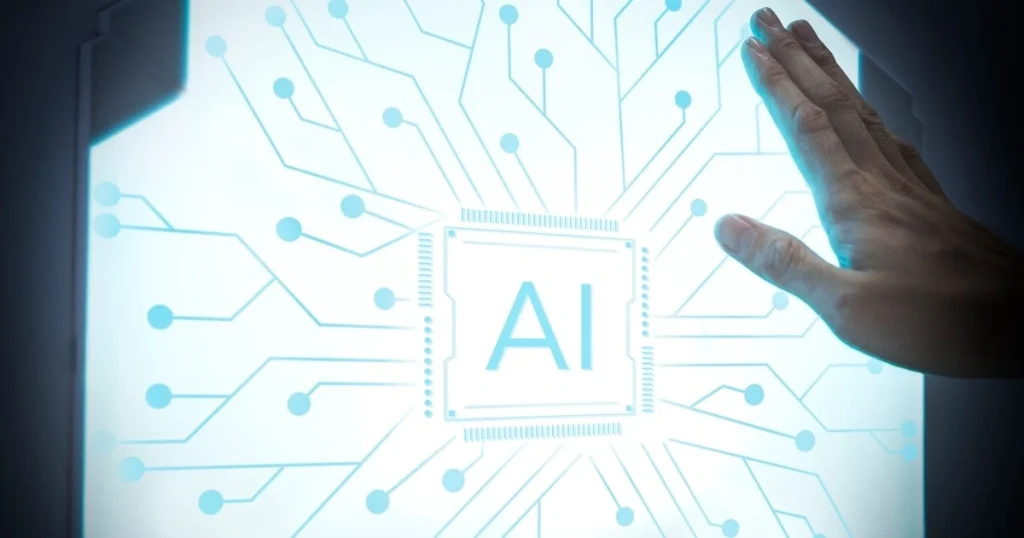 mão de uma pessoa sob um painel onde está escrito AI, artificial intelligence, ilustrando artigo de blog sobre inteligencia artificial no marketing